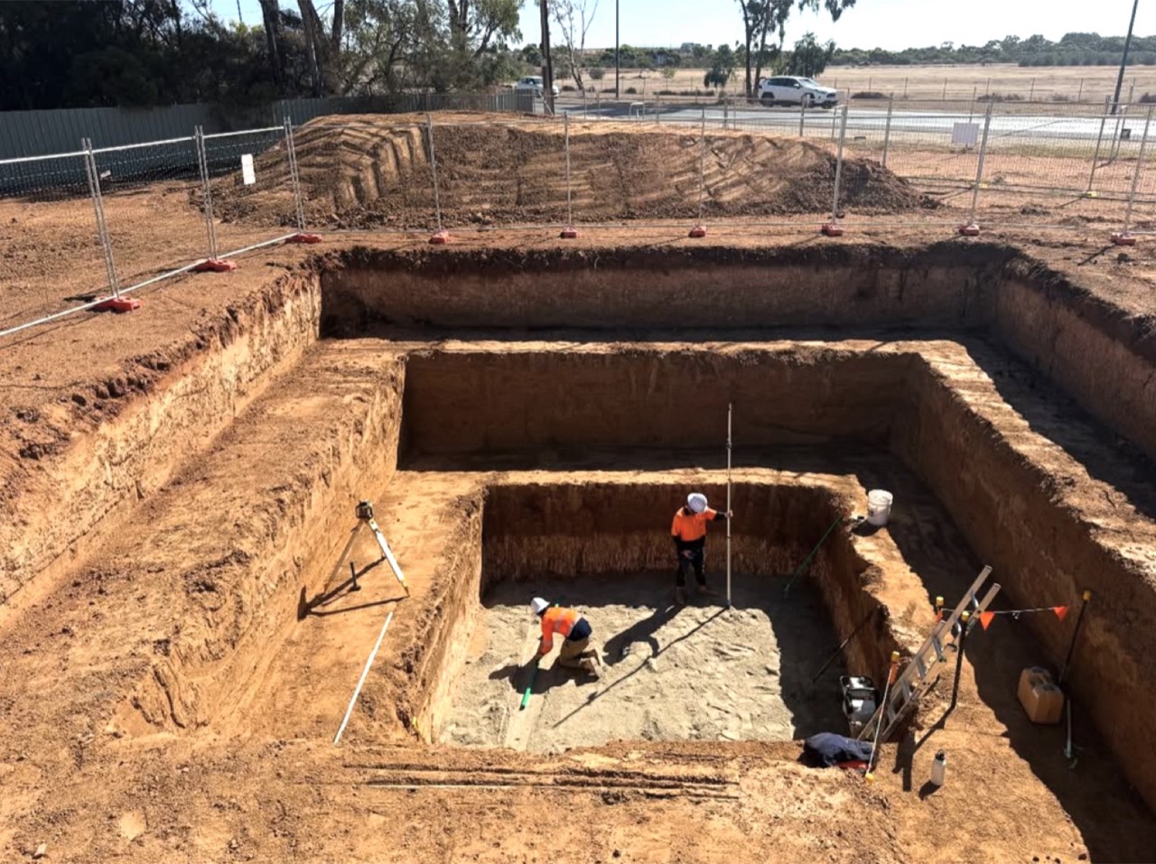 Stepped excavation with survey gear